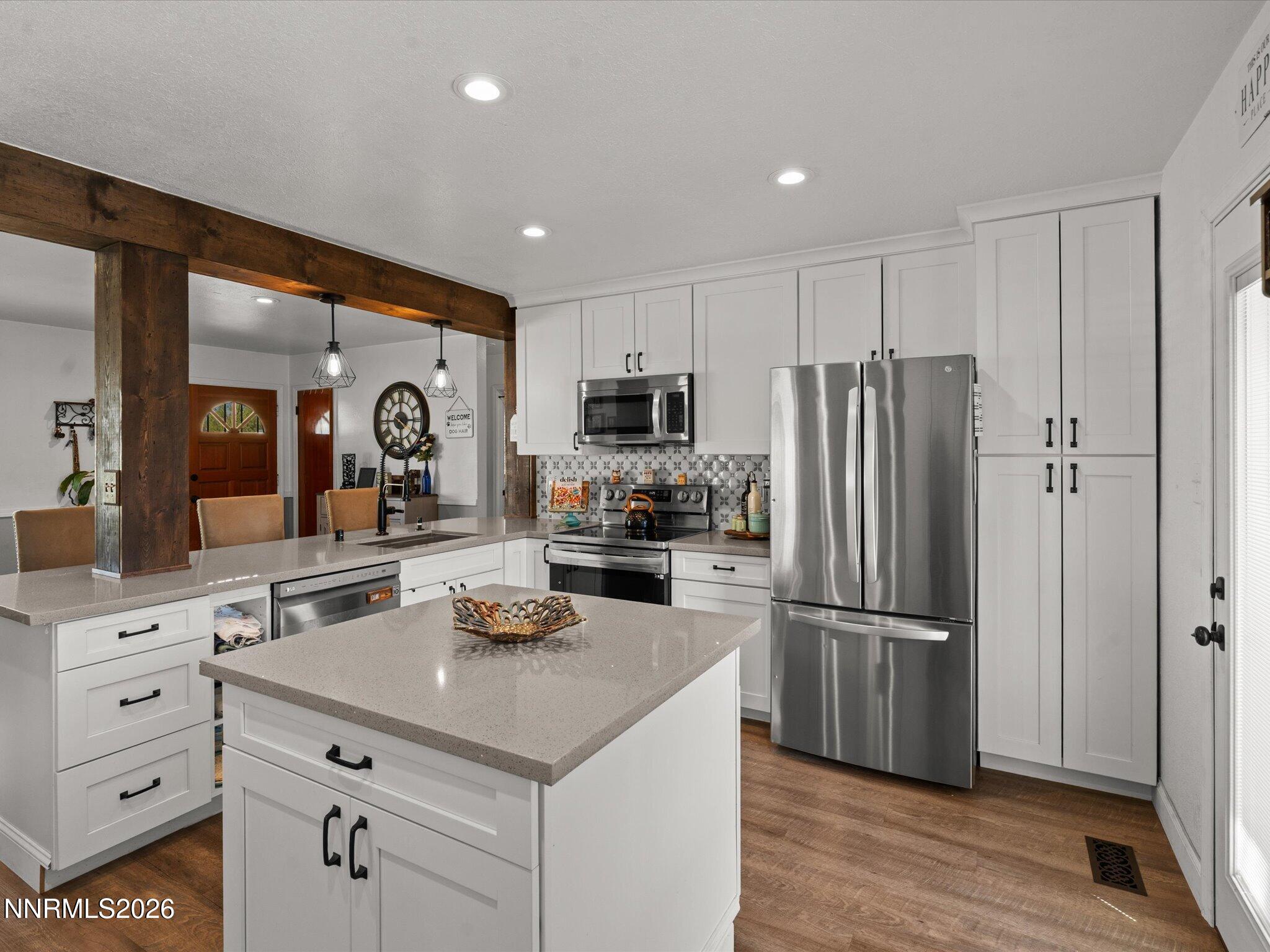 1030 4th Street Sparks, NV 89431 - Photo 14 of 26 a kitchen with white cabinets and stainless steel appliances