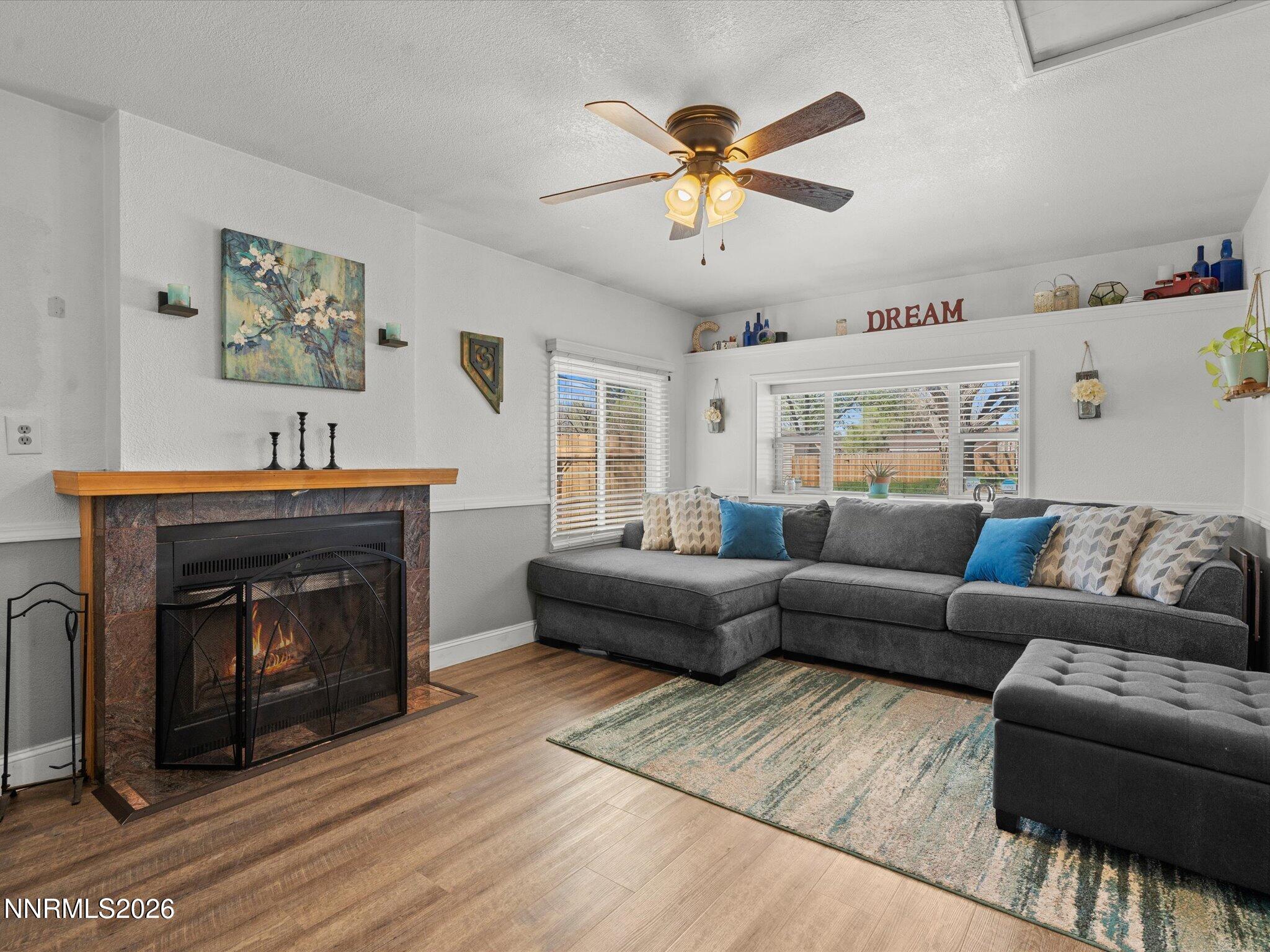 1030 4th Street Sparks, NV 89431 - Photo 19 of 26 a living room with furniture a fireplace and a window