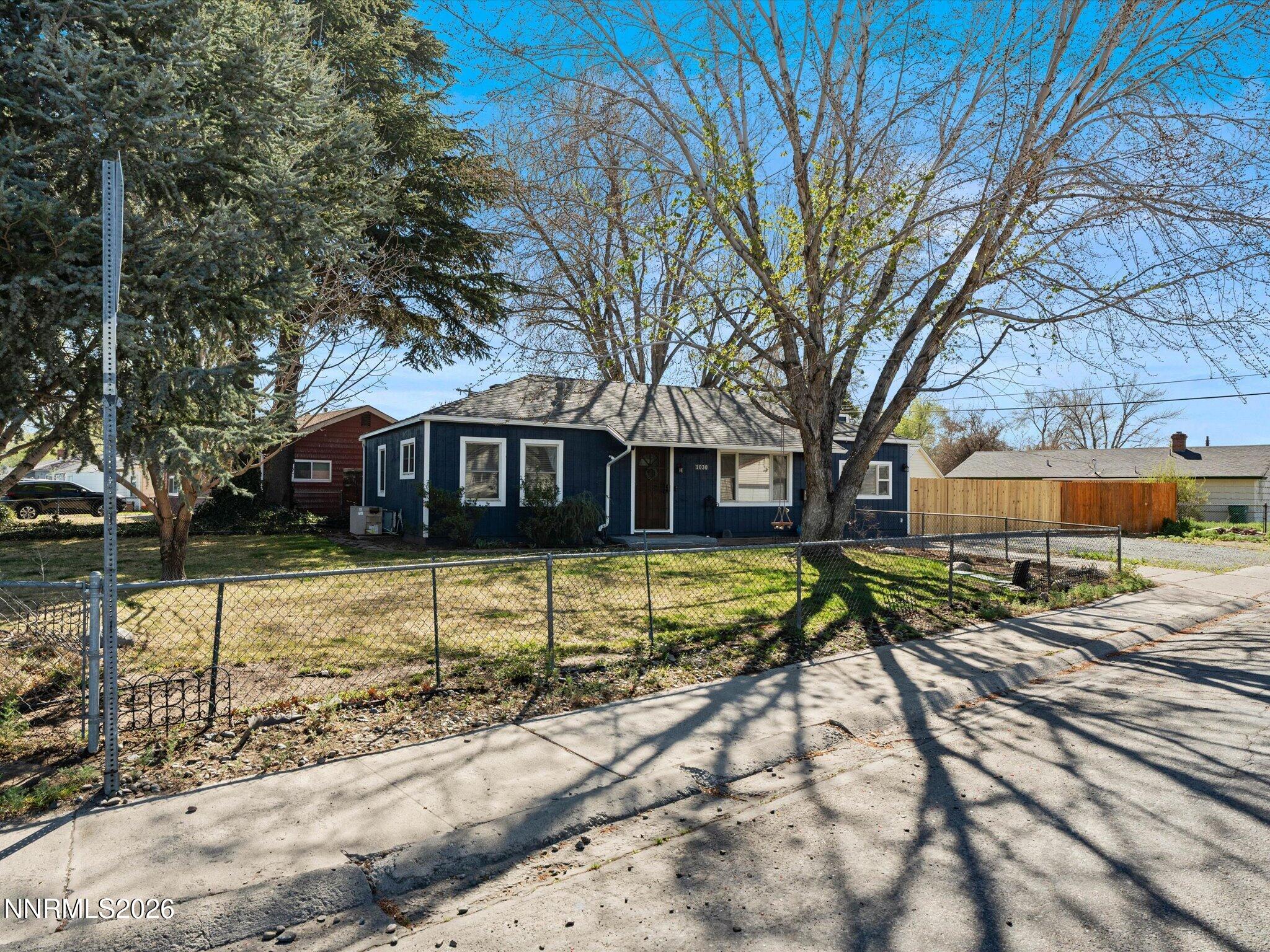 1030 4th Street Sparks, NV 89431 - Photo 23 of 26 a front view of a house with a yard