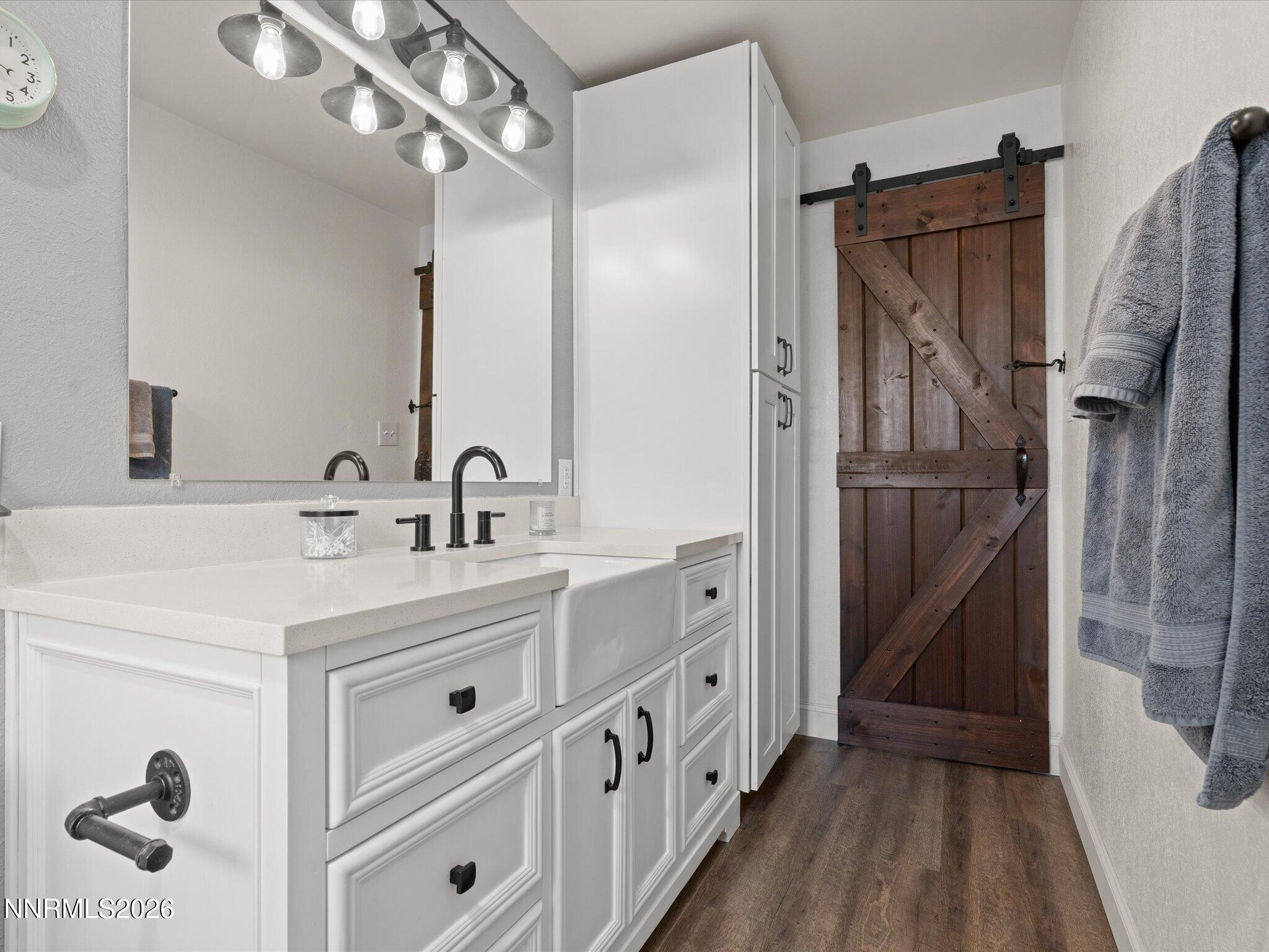 1030 4th Street Sparks, NV 89431 - Photo 5 of 26 a bathroom with a double vanity sink a mirror and shower