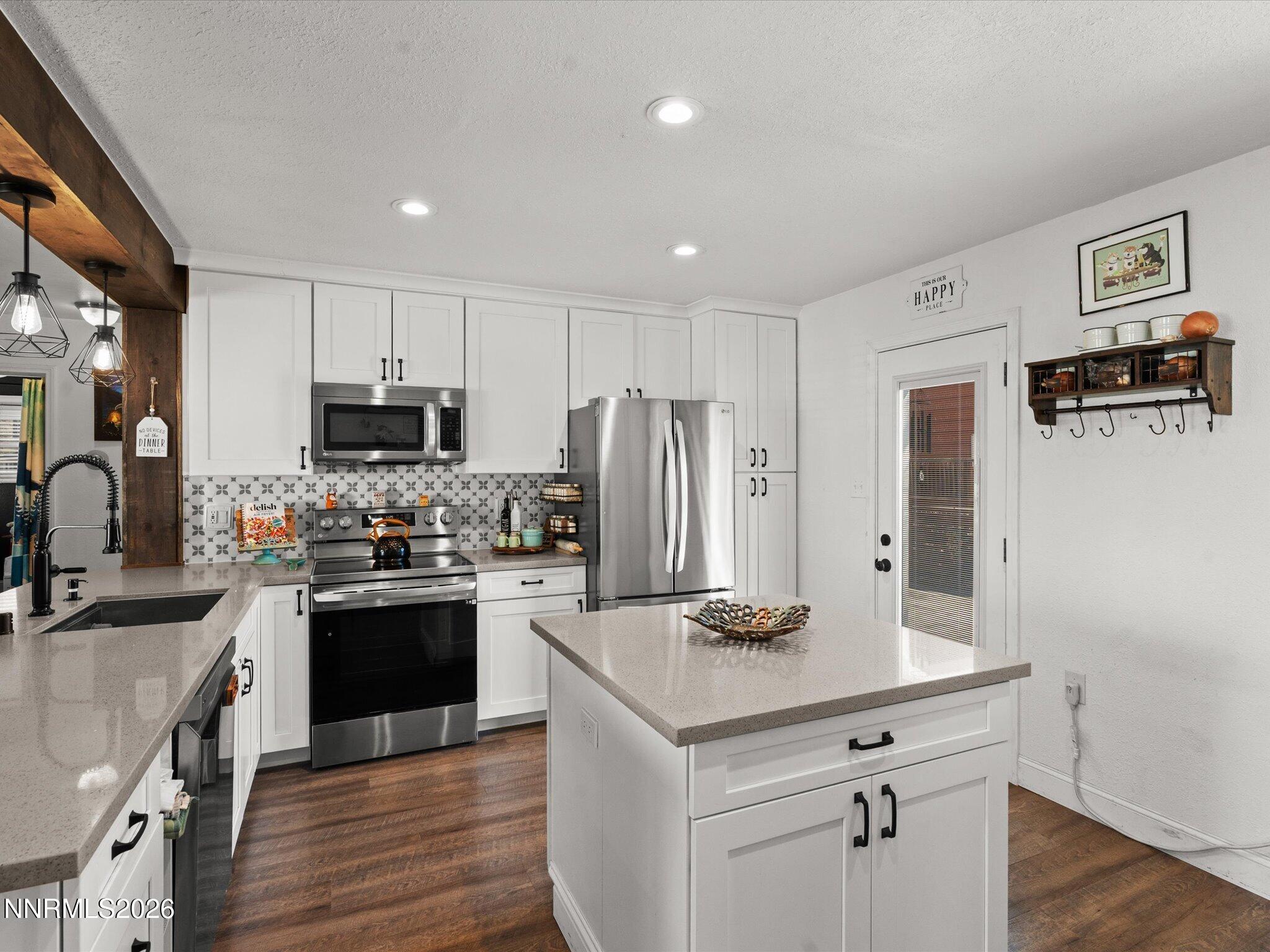 1030 4th Street Sparks, NV 89431 - Photo 6 of 26 a kitchen with kitchen island granite countertop a sink stove and refrigerator