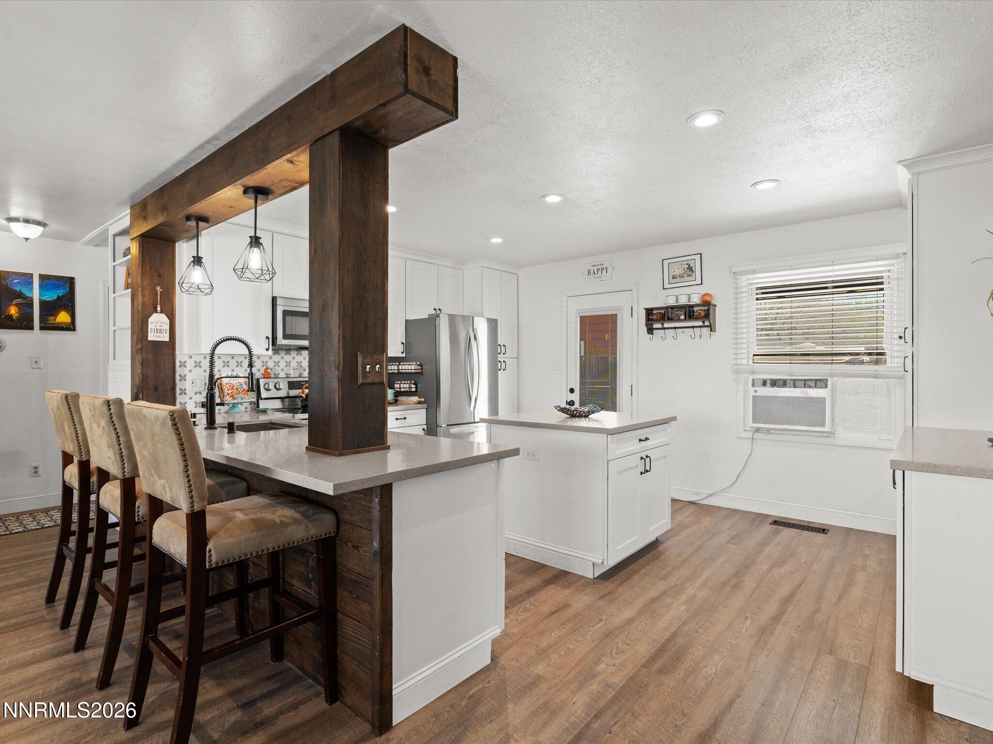 1030 4th Street Sparks, NV 89431 - Photo 7 of 26 a kitchen with sink a table and chairs