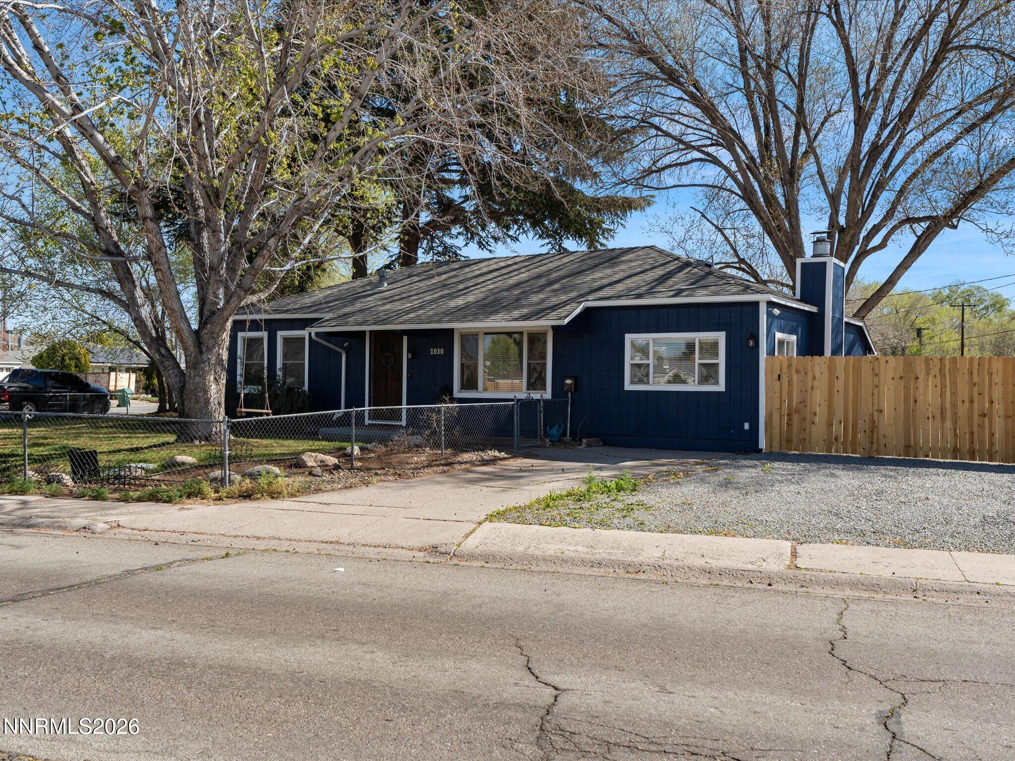 1030 4th Street Sparks, NV 89431 - Photo 10 of 26 a front view of a house with a yard and garage