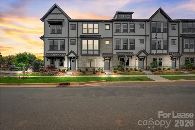 a front view of a residential apartment building with a yard