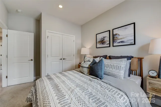 a bedroom with bed and a potted plant
