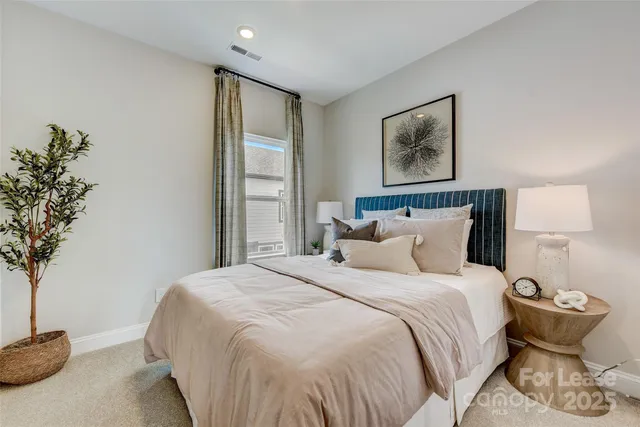 a bedroom with bed and painting on the wall