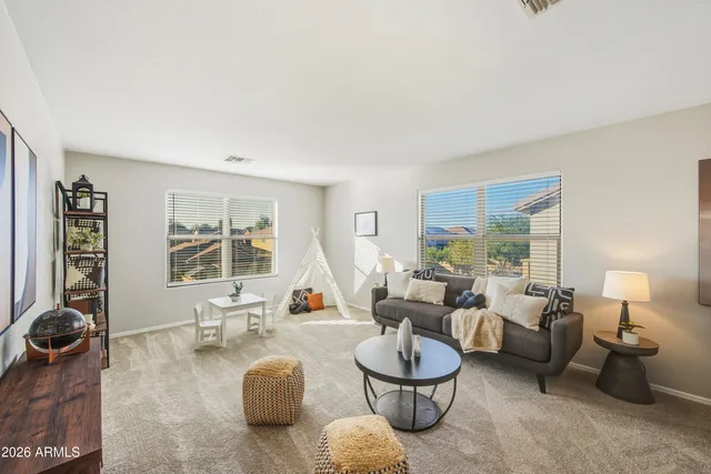 a living room with furniture and a large window