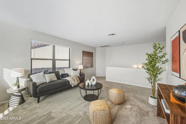 a living room with furniture and a potted plant