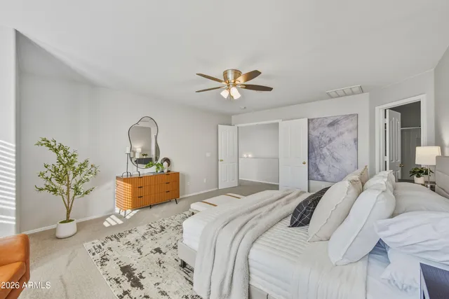 a bedroom with a large bed and a chandelier