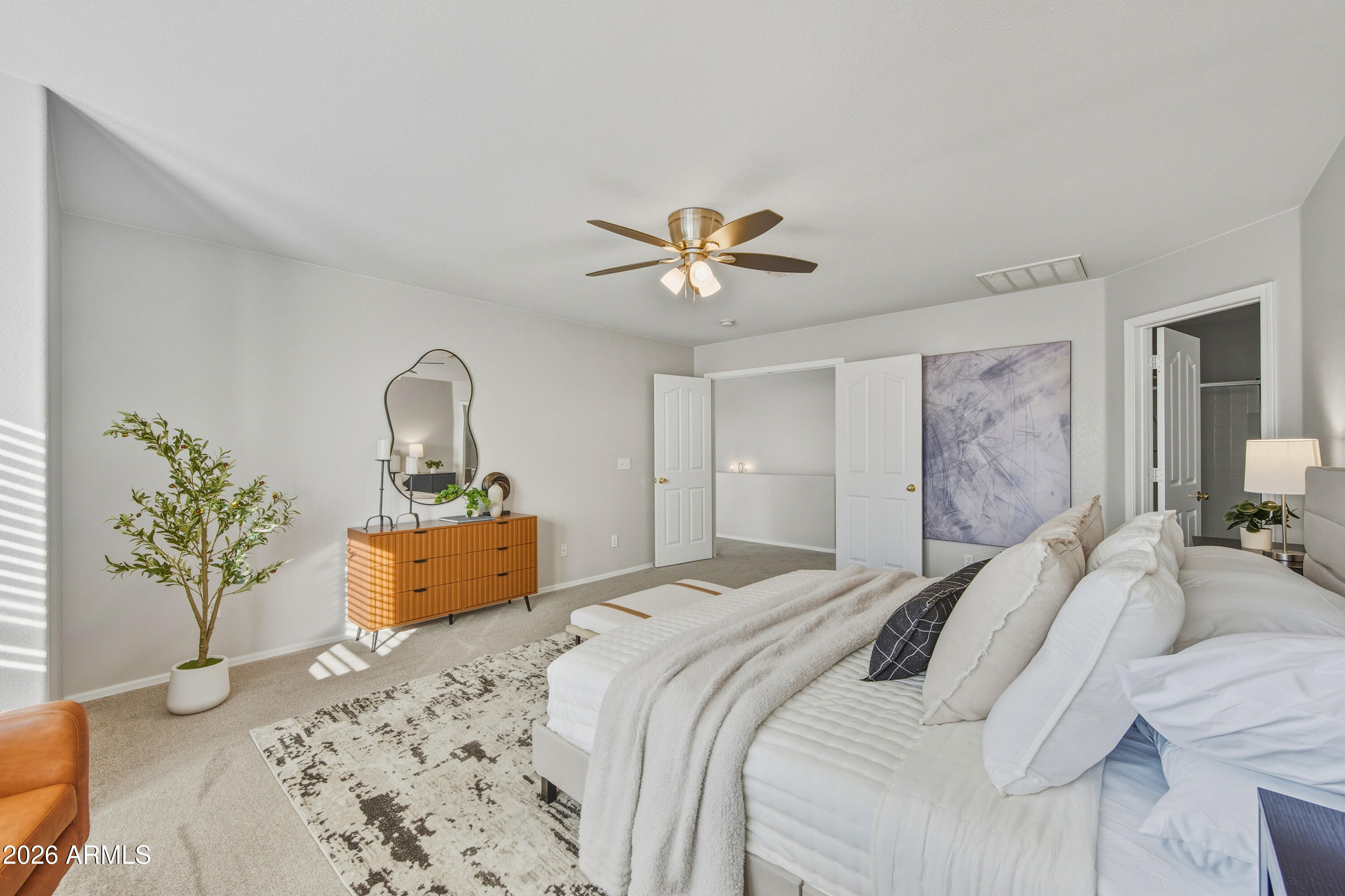 45651 West Barbara Lane Maricopa, AZ 85139 - Photo 14 of 32 a bedroom with a large bed and a chandelier