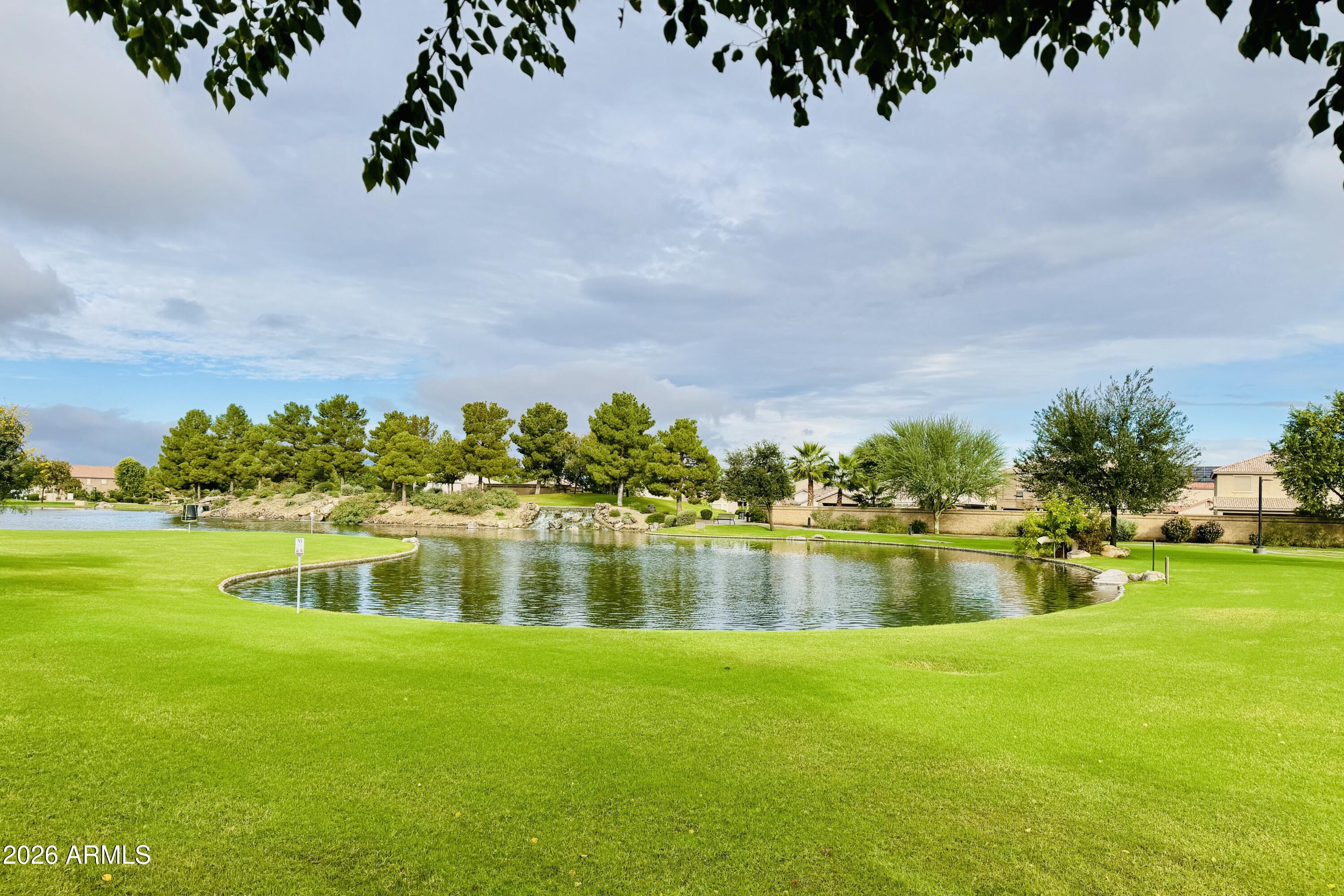 45651 West Barbara Lane Maricopa, AZ 85139 - Photo 29 of 32 a view of a lake with houses in the back