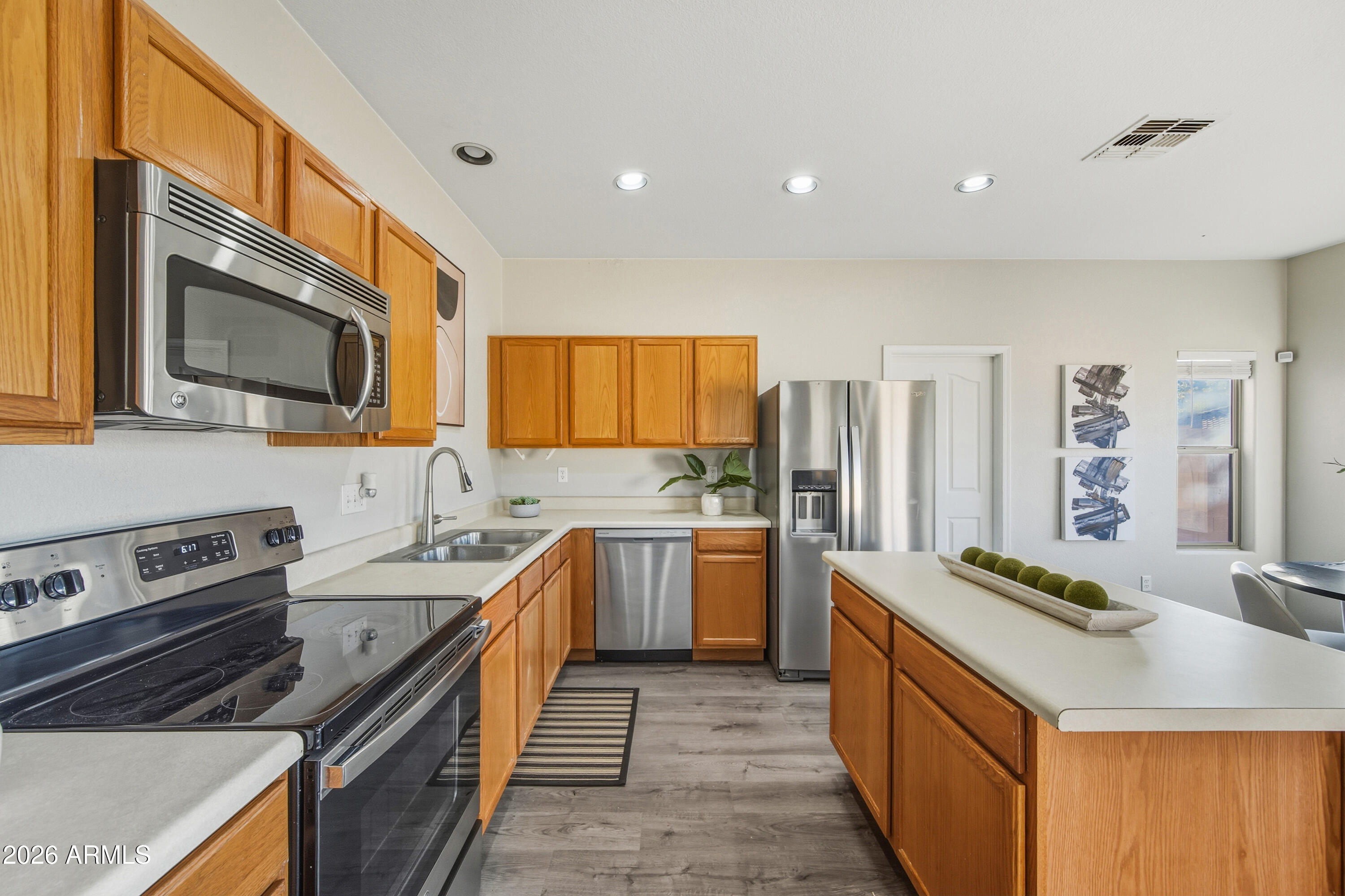 45651 West Barbara Lane Maricopa, AZ 85139 - Photo 8 of 32 a kitchen with stainless steel appliances granite countertop a sink stove and refrigerator