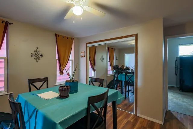 a view of a dining room with furniture and wooden floor