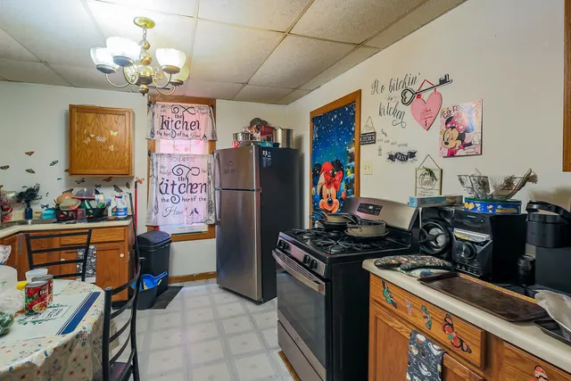 a kitchen with stainless steel appliances granite countertop a refrigerator and a stove
