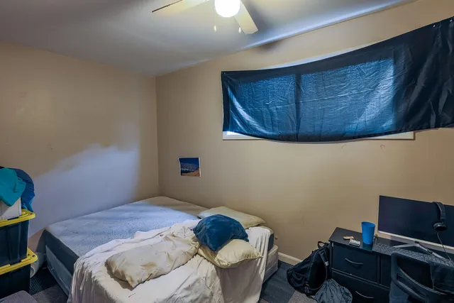 a bedroom with a bed and a window