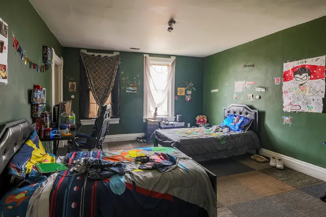 a bedroom with bed and a window