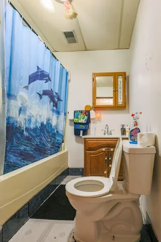 a bathroom with a sink a toilet and a mirror