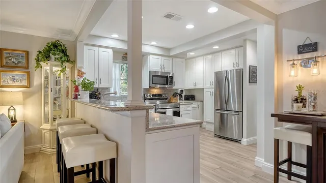 a kitchen with sink cabinets and wooden floor