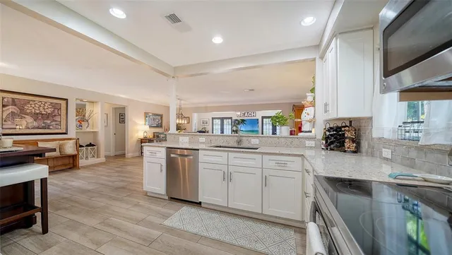 a kitchen with a refrigerator a sink and a stove top oven