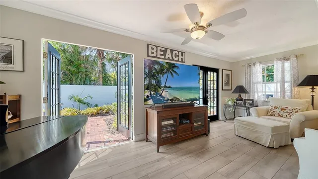a living room with furniture and a floor to ceiling window