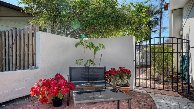 a view of a chair and table in the backyard