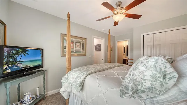 a bedroom with a bed and a flat tv screen on a dresser