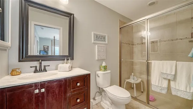 a bedroom with a bed a chair and potted plant