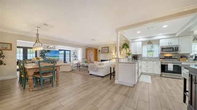 a view of kitchen with wooden floor and electronic appliances