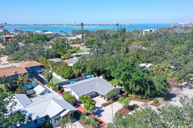 an aerial view of a house with yard swimming pool and outdoor seating