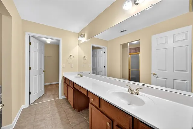 a bathroom with a glass shower door