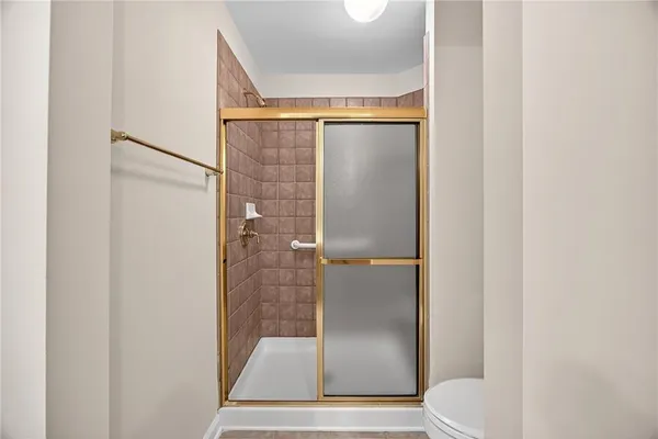 a bathroom with a glass shower door