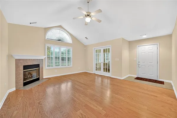 a view of livingroom with fireplace ceiling fan and window