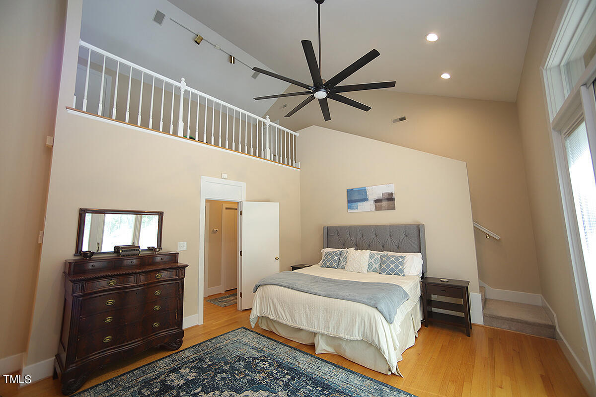 1108 Hymettus Court Raleigh, NC 27607 - Photo 19 of 48 a bedroom with a bed and wooden floor