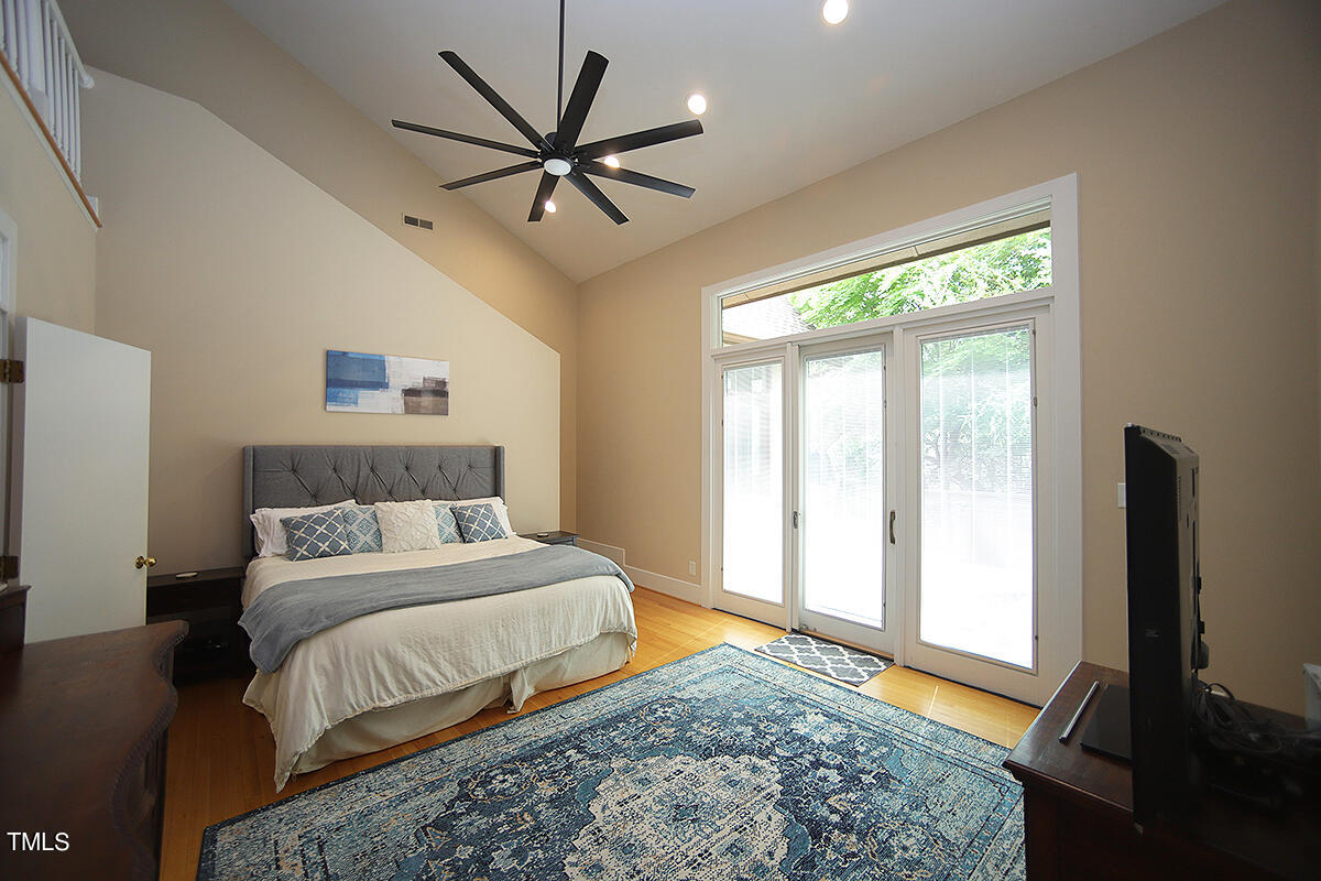1108 Hymettus Court Raleigh, NC 27607 - Photo 20 of 48 a bedroom with a large bed and a flat screen tv