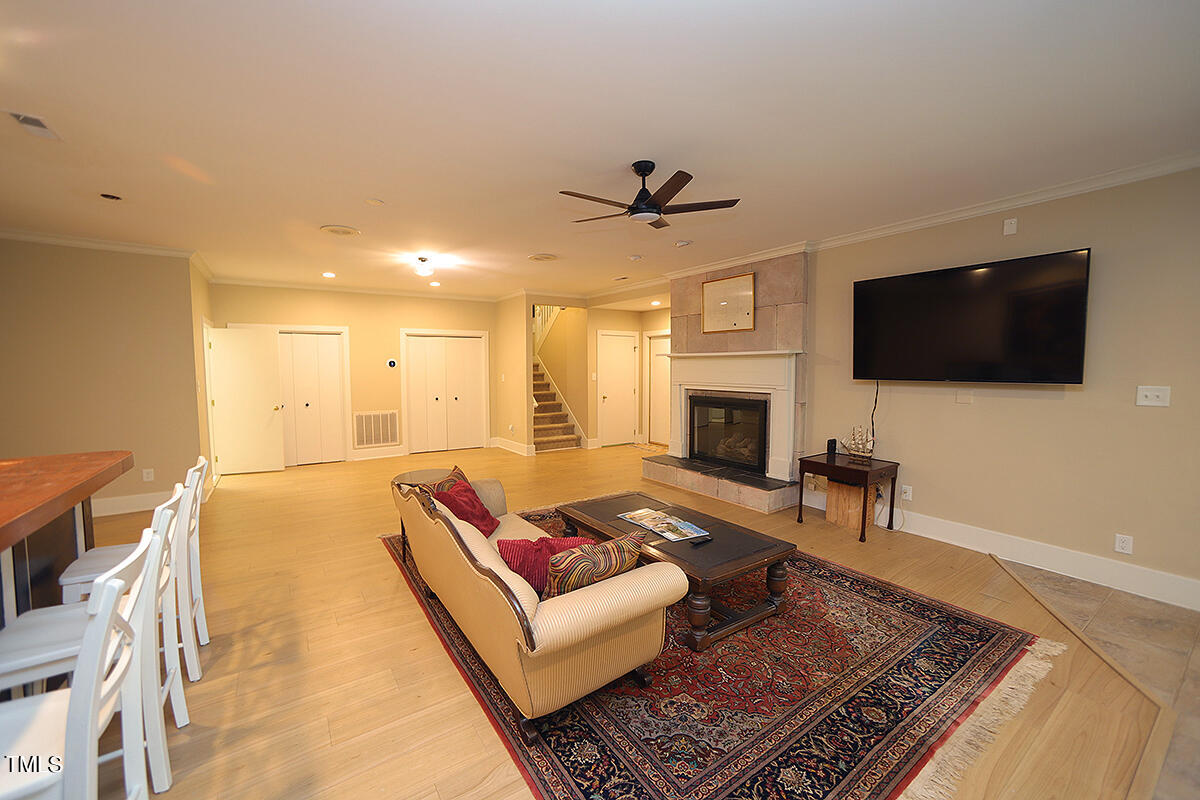 1108 Hymettus Court Raleigh, NC 27607 - Photo 30 of 48 a living room with furniture and a flat screen tv