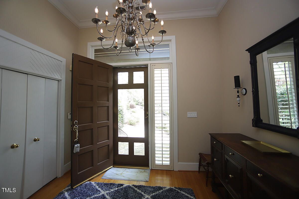 1108 Hymettus Court Raleigh, NC 27607 - Photo 3 of 48 a dining room with chandelier and wooden floor