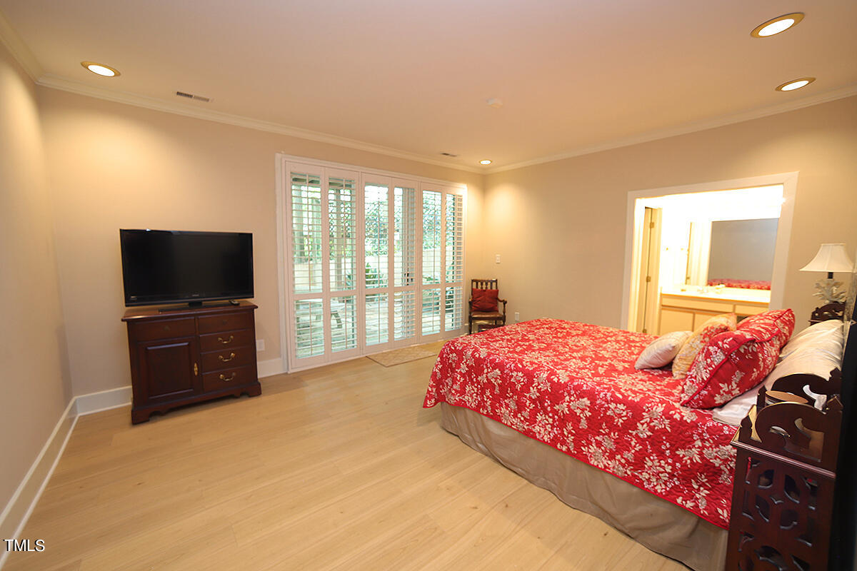 1108 Hymettus Court Raleigh, NC 27607 - Photo 33 of 48 a bedroom with a bed and a television