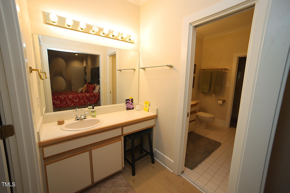 1108 Hymettus Court Raleigh, NC 27607 - Photo 34 of 48 a bathroom with a sink and mirror with toilet