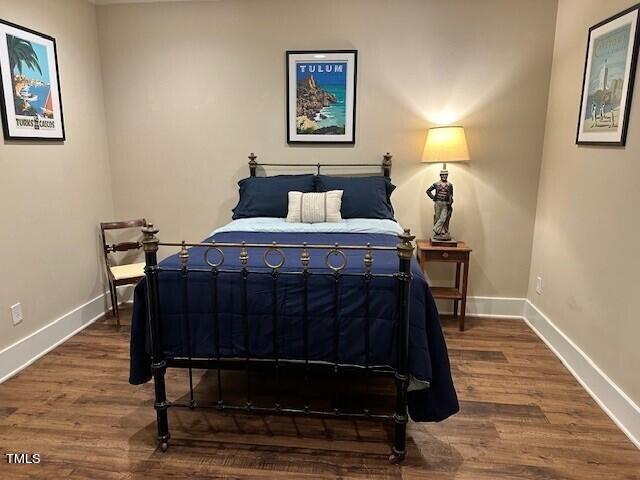 1108 Hymettus Court Raleigh, NC 27607 - Photo 37 of 48 a bedroom with a bed and wooden floor