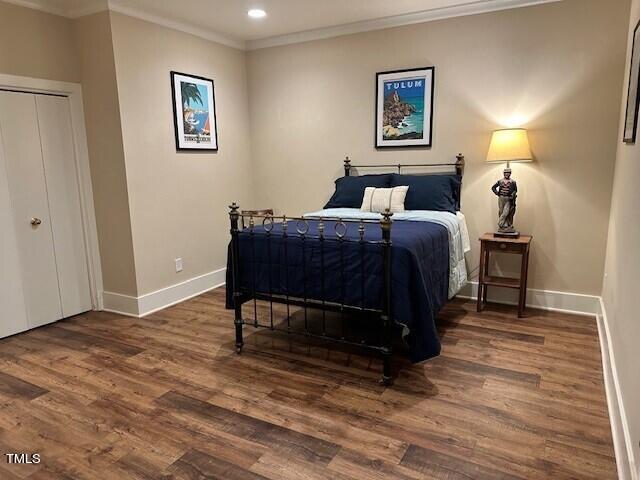 1108 Hymettus Court Raleigh, NC 27607 - Photo 38 of 48 a bedroom with a bed a lamp and a dresser