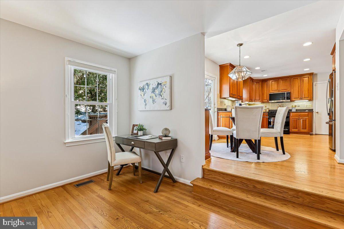 3105 Miller Heights Road Oakton, VA 22124 - Photo 11 of 60 a living room with a dining table and a wooden floor