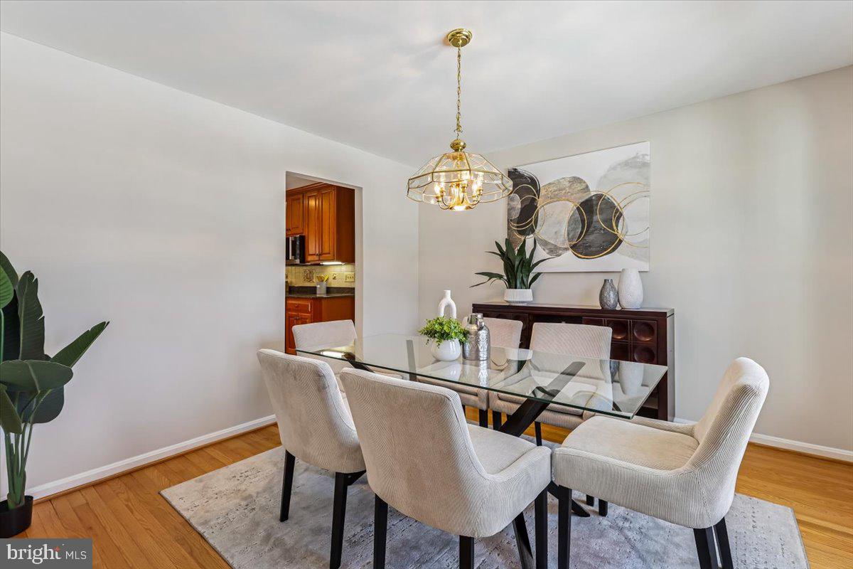 3105 Miller Heights Road Oakton, VA 22124 - Photo 27 of 60 a view of a dining room with furniture wooden floor and a chandelier