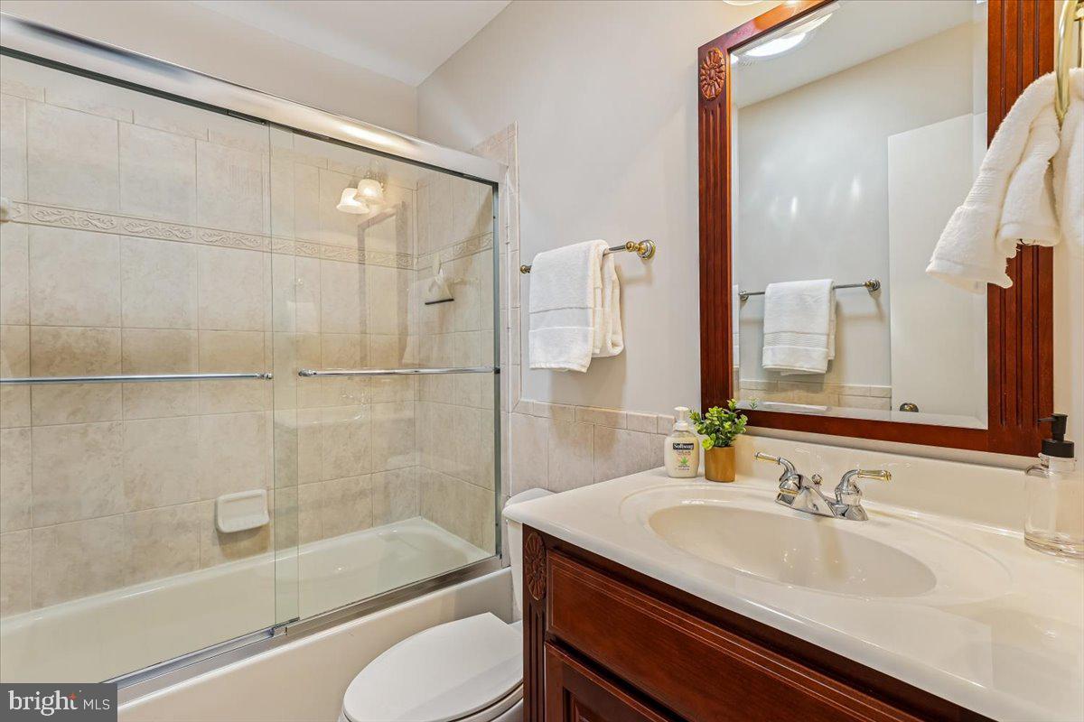 3105 Miller Heights Road Oakton, VA 22124 - Photo 43 of 60 a bathroom with a granite countertop sink toilet and shower