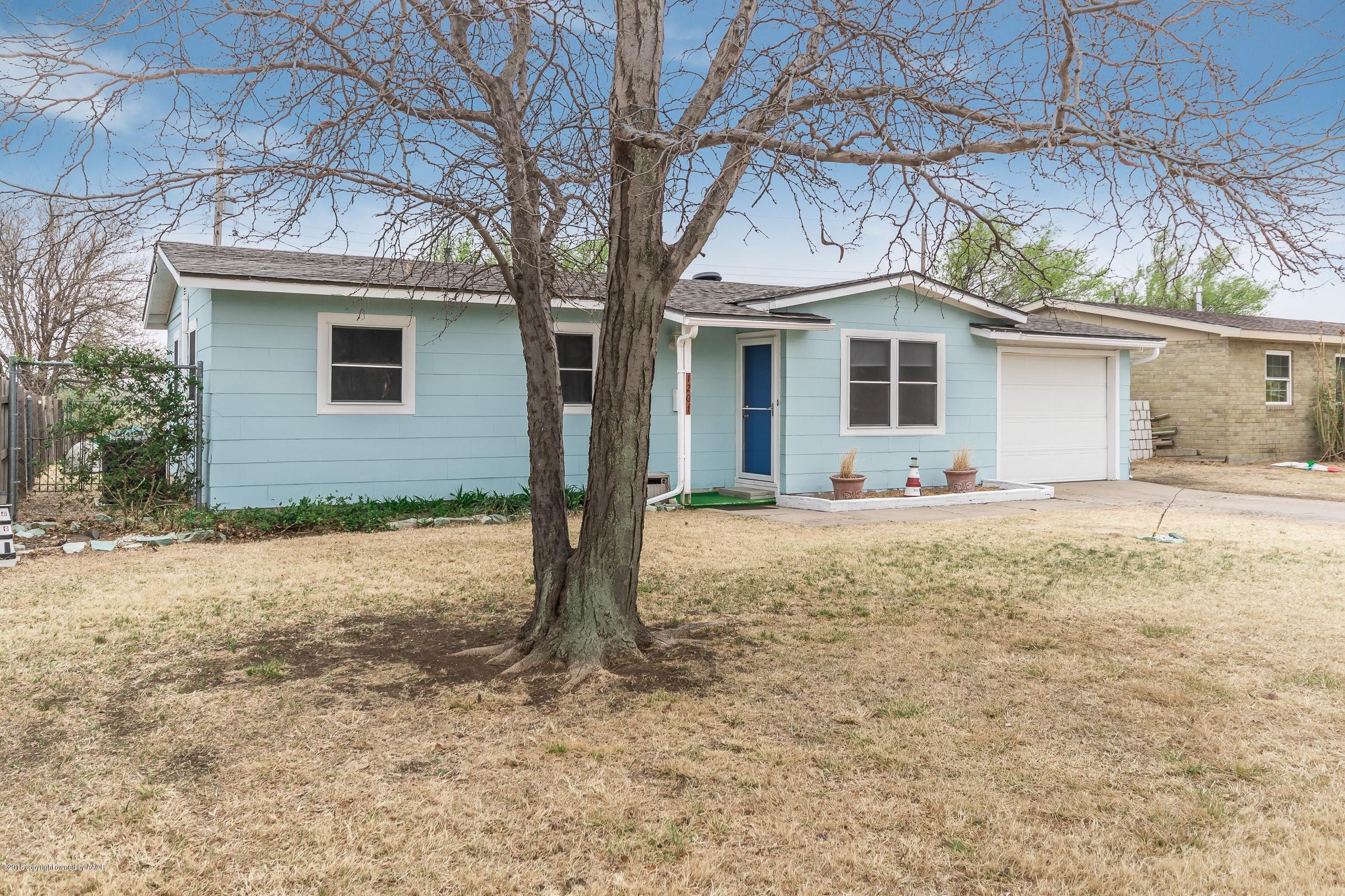 1201 Southwest 48th Avenue Amarillo, TX 79110 - Photo 1 of 18 a front view of a house with yard and seating space