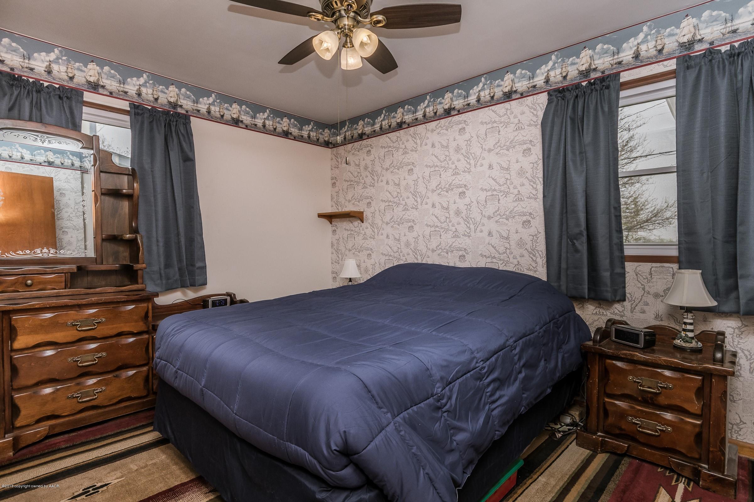 1201 Southwest 48th Avenue Amarillo, TX 79110 - Photo 11 of 18 a bedroom with a bed and a flat screen tv