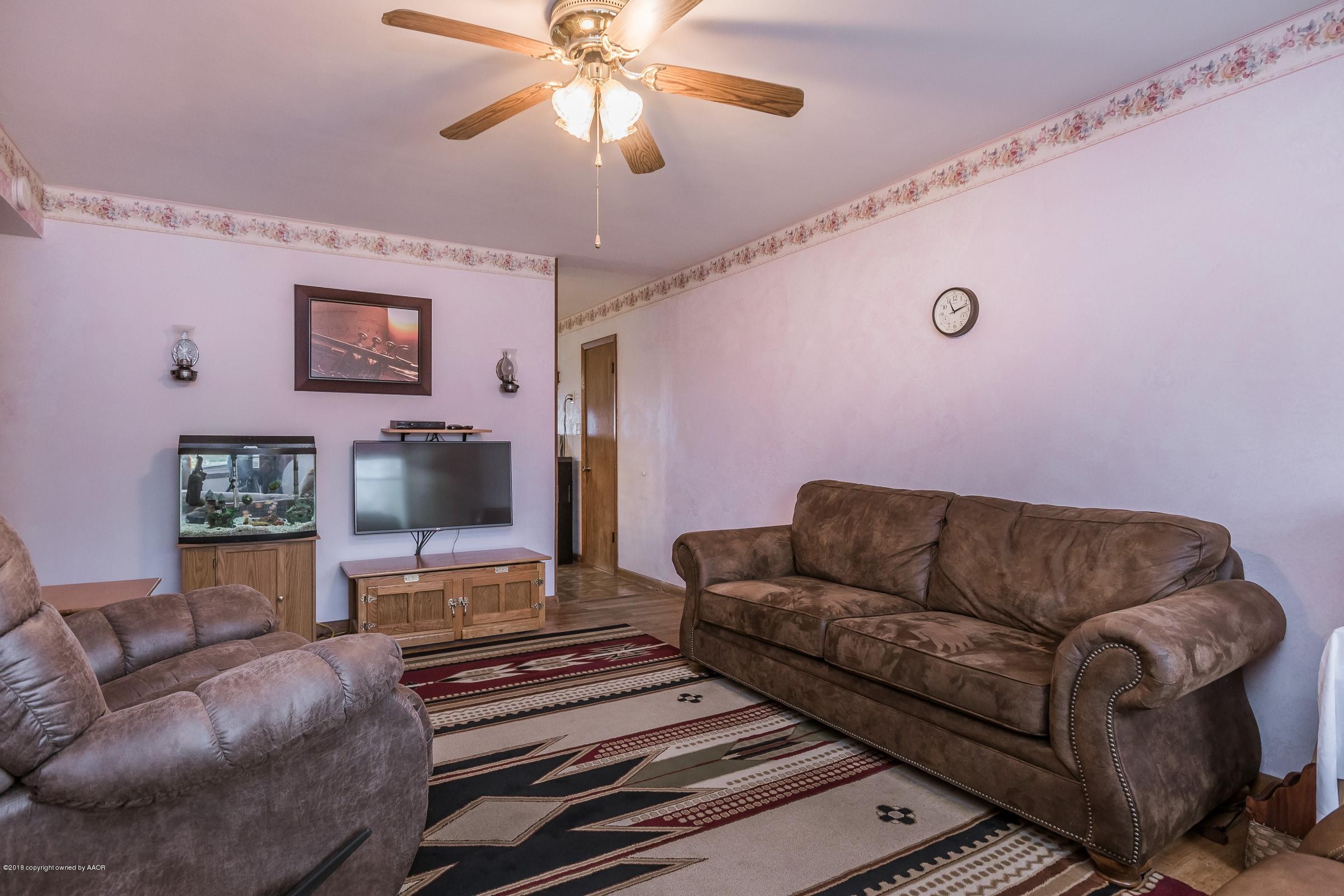 1201 Southwest 48th Avenue Amarillo, TX 79110 - Photo 3 of 18 a living room with furniture and a flat screen tv