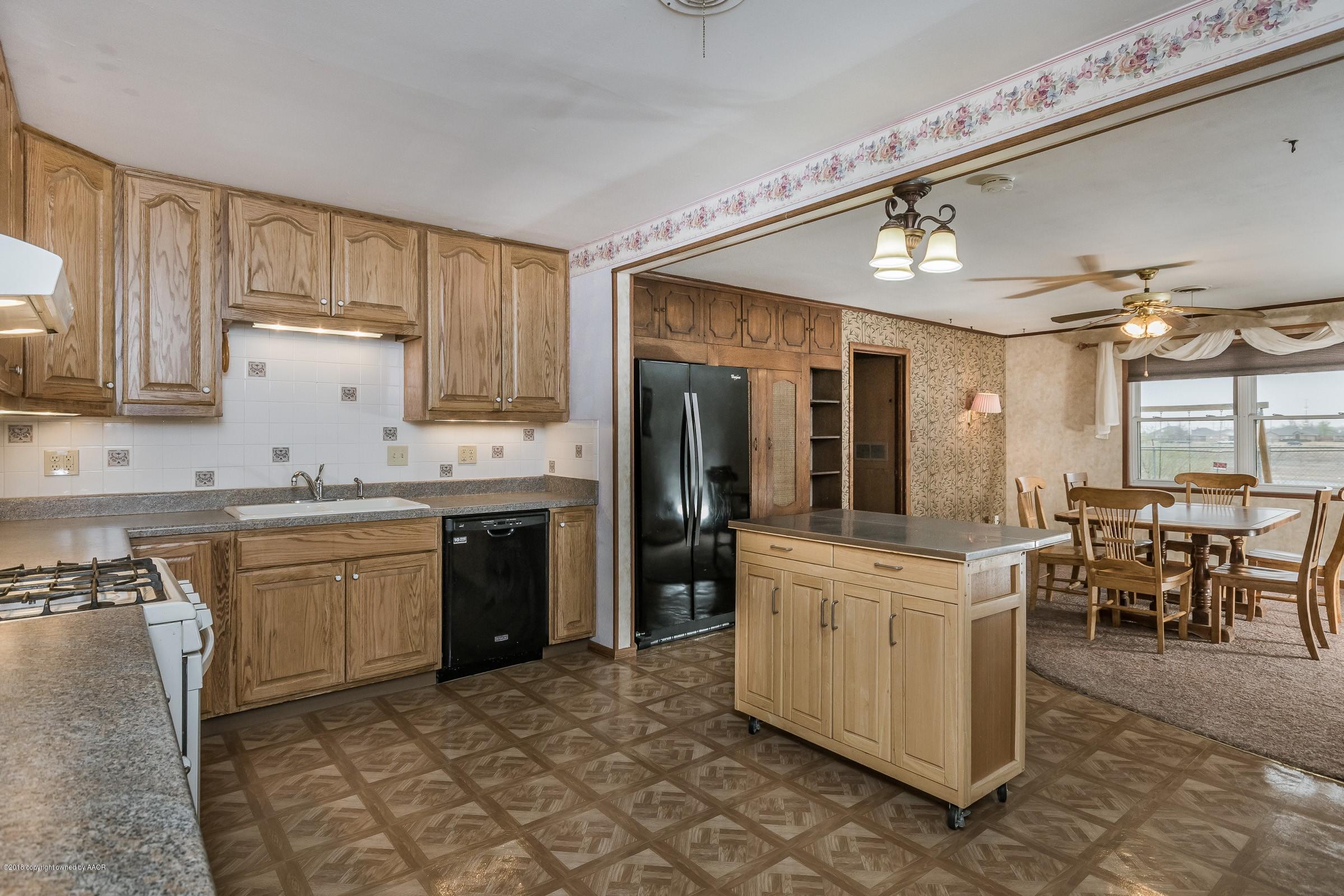 1201 Southwest 48th Avenue Amarillo, TX 79110 - Photo 6 of 18 a kitchen with a sink stove and cabinets