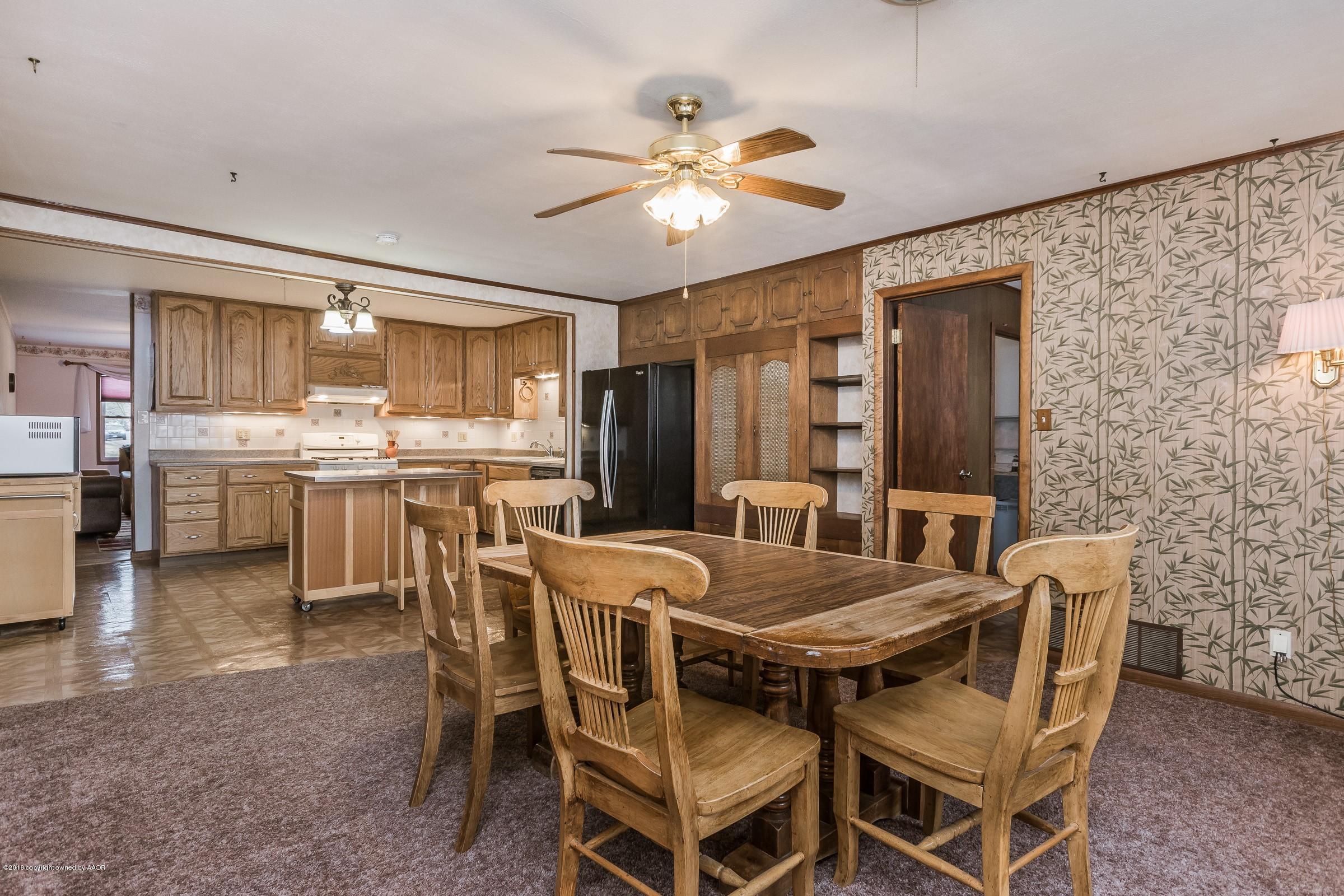 1201 Southwest 48th Avenue Amarillo, TX 79110 - Photo 8 of 18 a view of a dining room with furniture and wooden floor