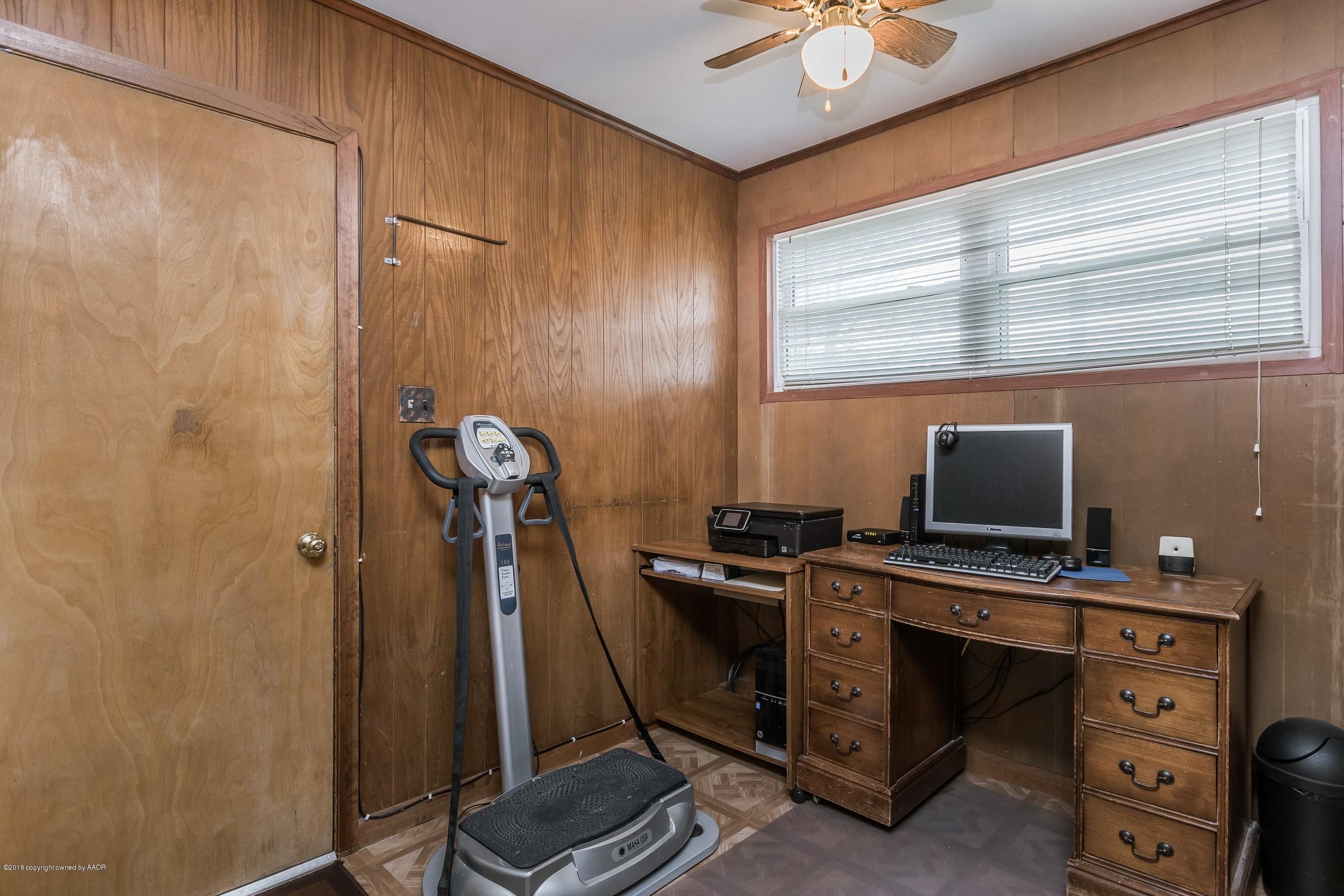 1201 Southwest 48th Avenue Amarillo, TX 79110 - Photo 9 of 18 a view of a workspace with furniture and a window