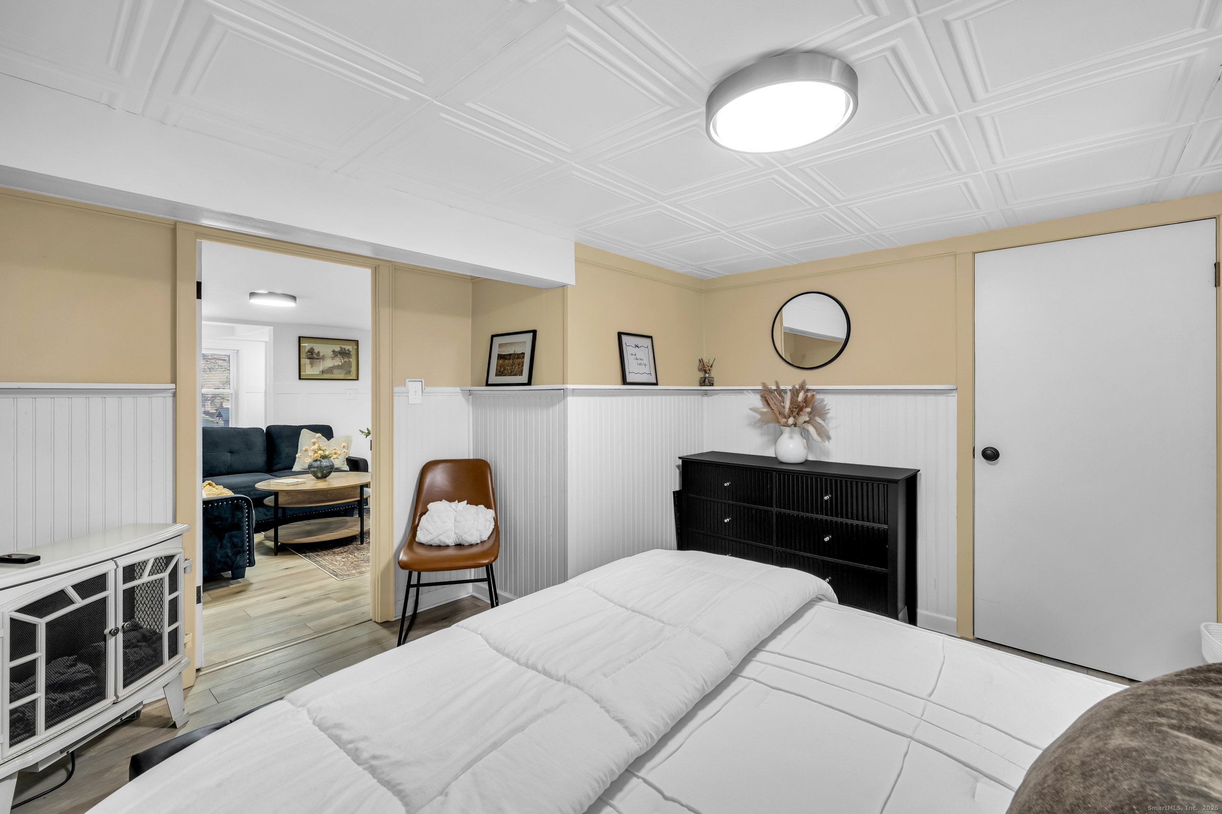 25 Cottage Grove Road Goshen, CT 06756 - Photo 11 of 38 a bedroom with a bed and a chandelier